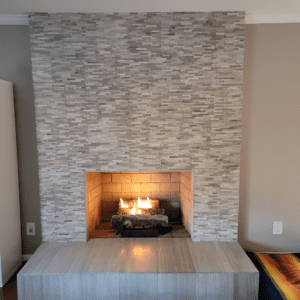 A fireplace with a stone surround and hearth.